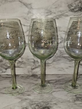 This set of three iridescent green blown glass wine glasses stands at 8.5 inches